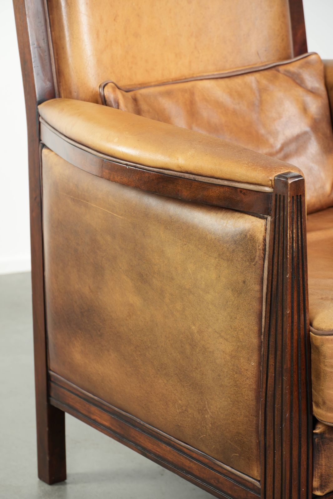 Furniture Comfortable Cognac Colored Art Deco Design Armchair Made Of Sheepskin Combined With Wood, With A High Back. photo
