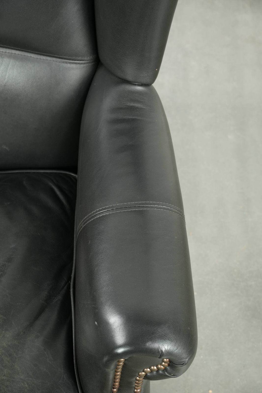 Black Cowhide Wing Armchair In A Classic English Style, Finished With Decorative Nails. photo vintage