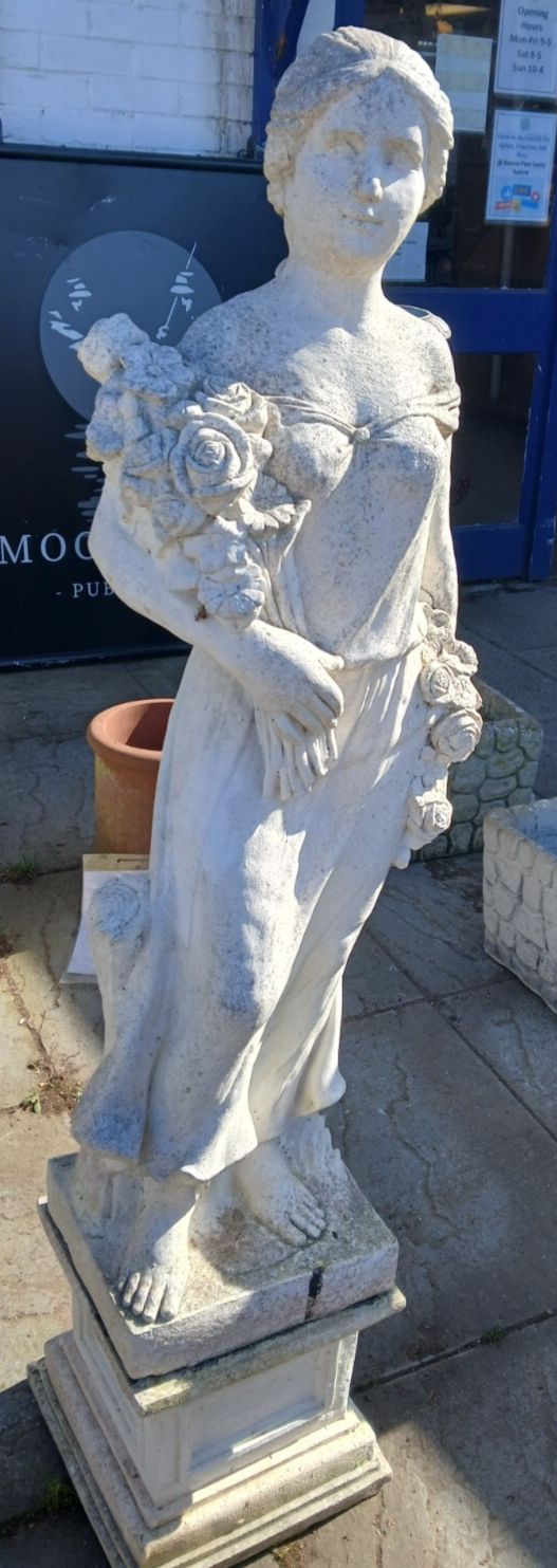 Weathered Concrete Statue Of Female Carrying Flowers photo 195.0