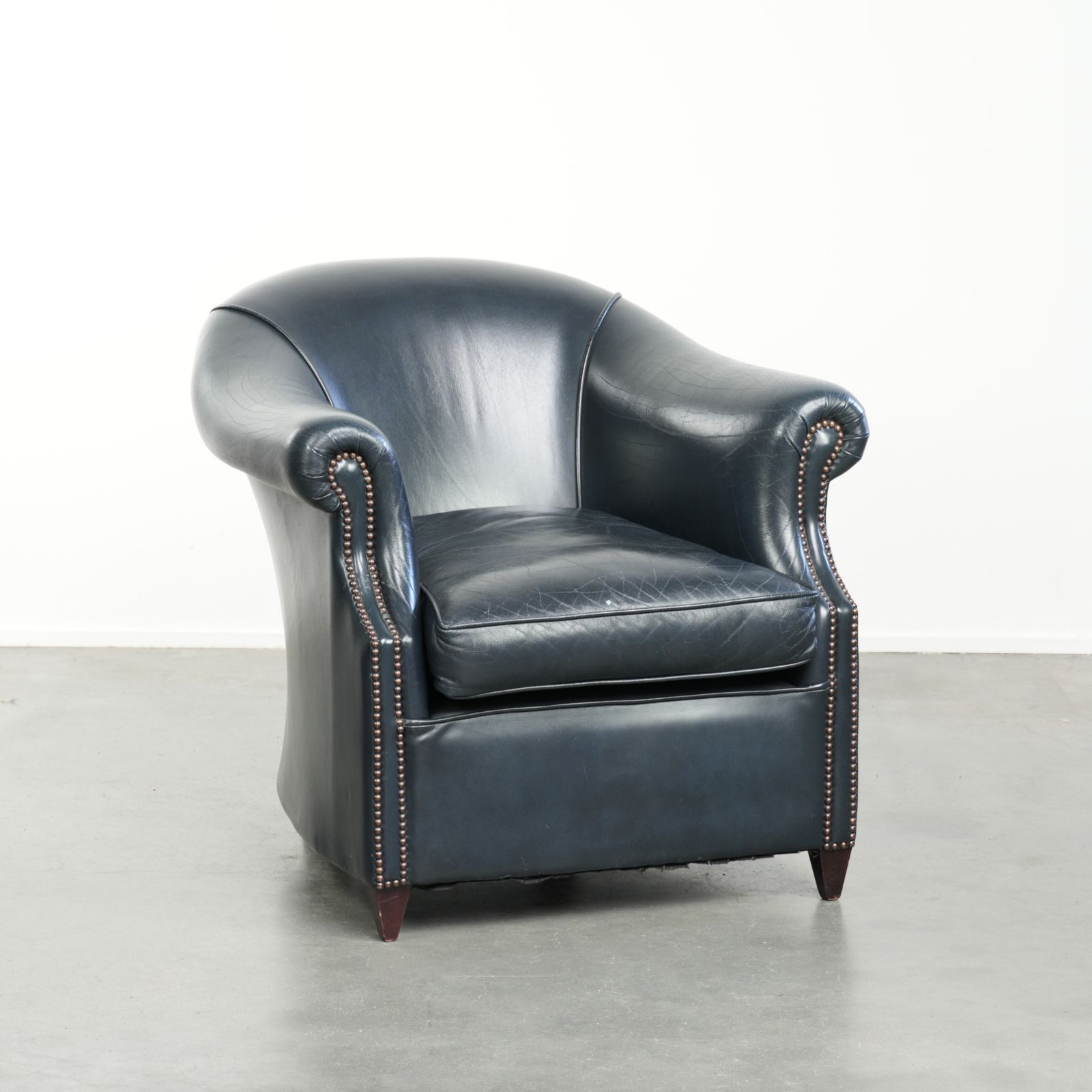 Dark Blue Club Armchair Made Of Cowhide Leather With A Timeless Design