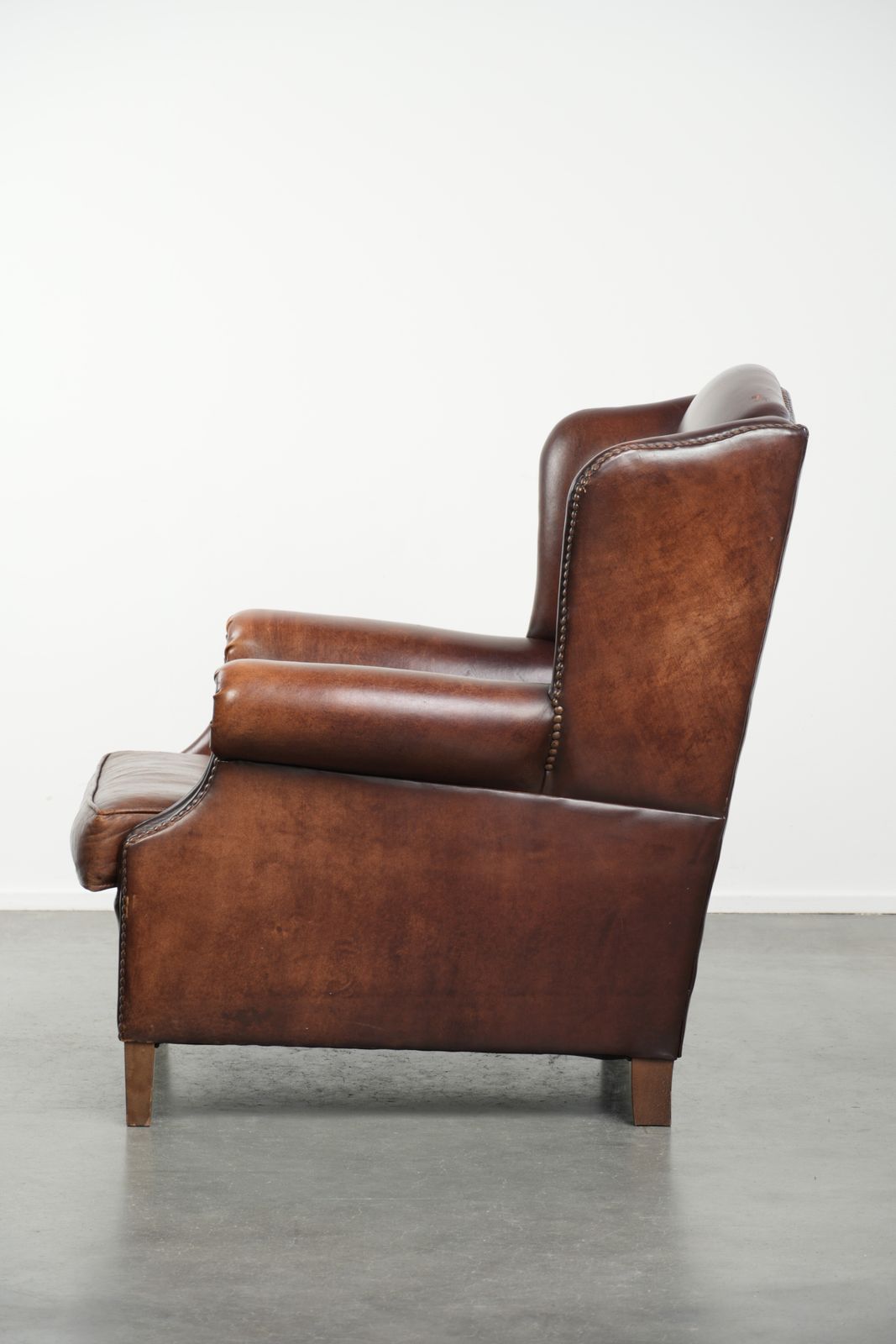 Elegant Vintage Sheepskin Wing Armchair With A Timeless English Look, Finished With Decorative Nails. photo 922.0