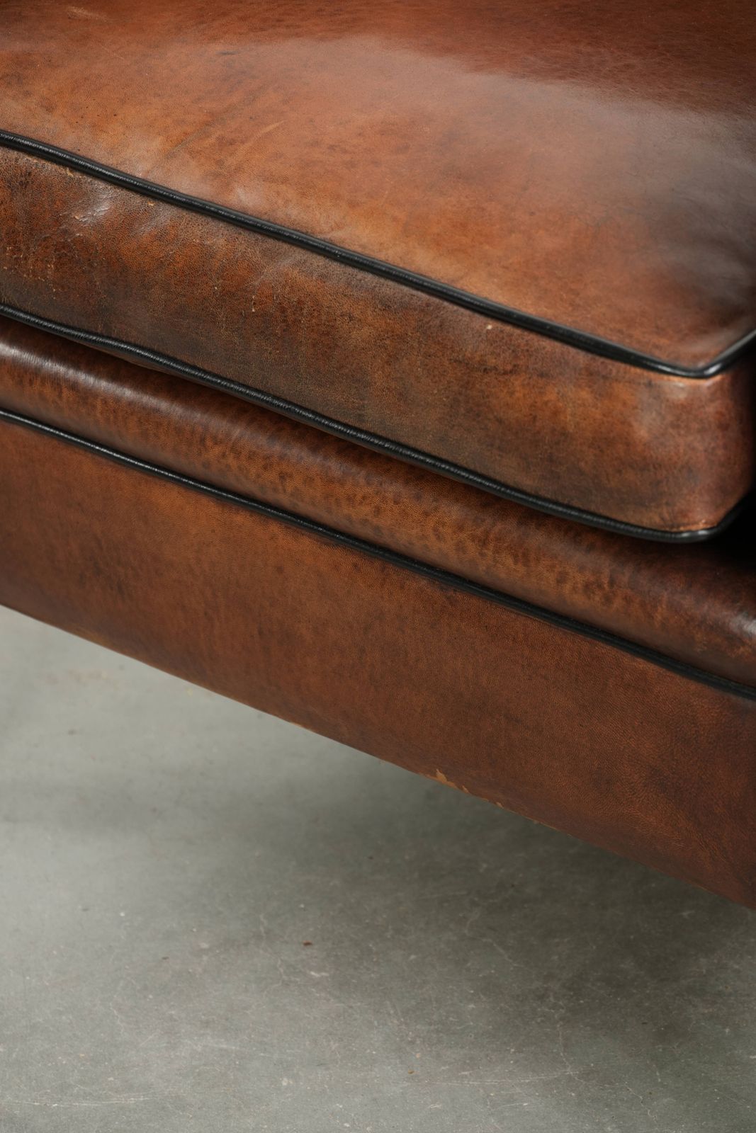 1203.0 Sleek Sheepskin Art Deco Design Armchair With Black Piping And A Beautiful Warm Color photo