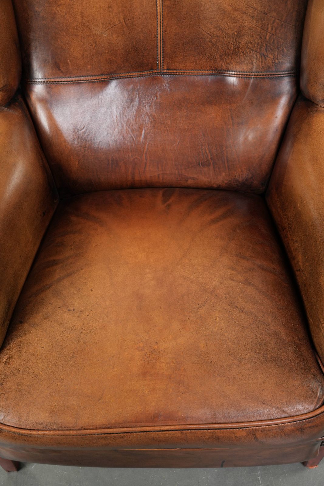 Comfortable Wing Armchair Made Of Sheepskin Finished With Decorative Studs And A Characterful English Style Appearance. photo vinterior