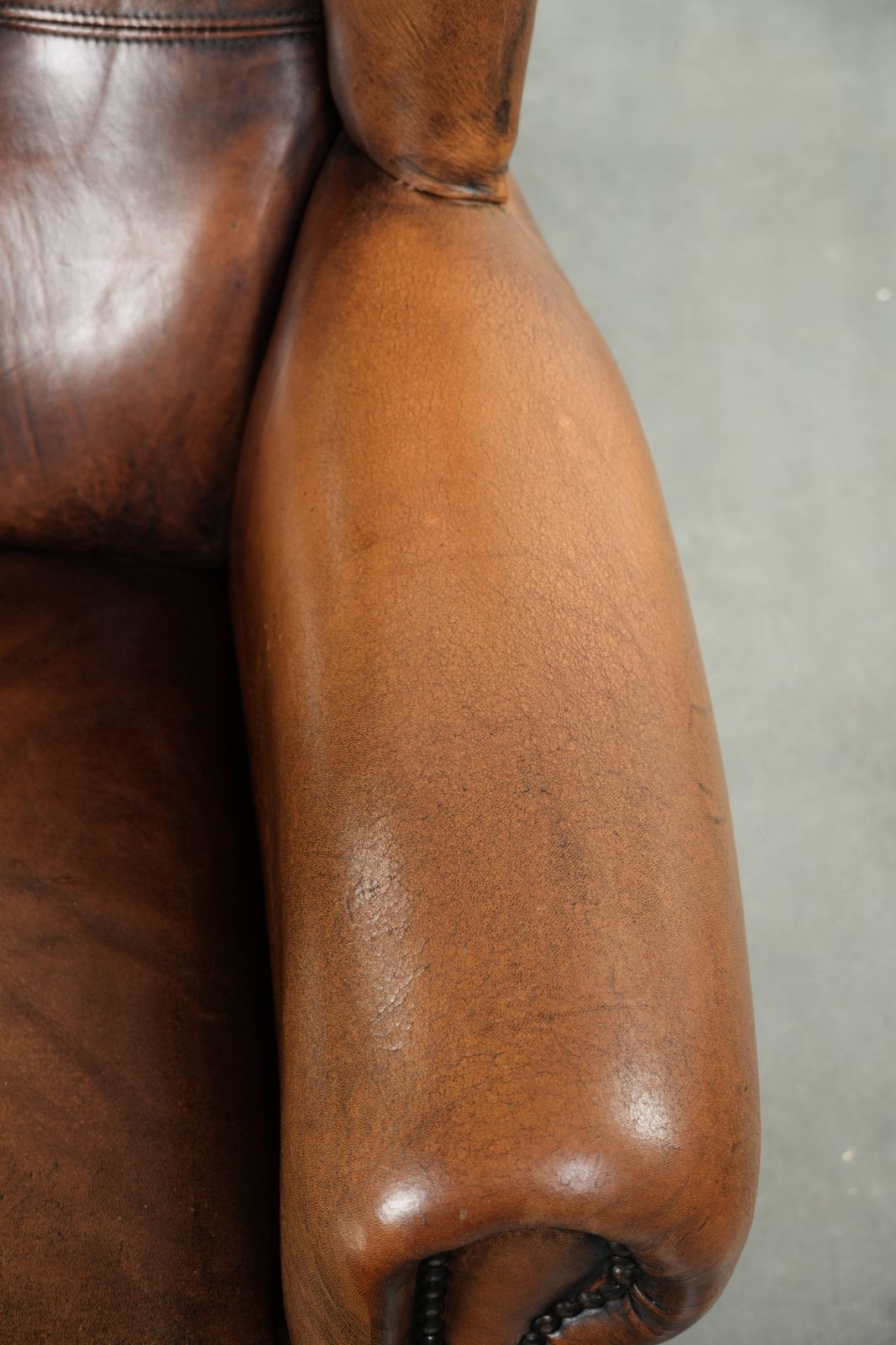 Comfortable Wing Armchair Made Of Sheepskin Finished With Decorative Studs And A Characterful English Style Appearance. photo vintage