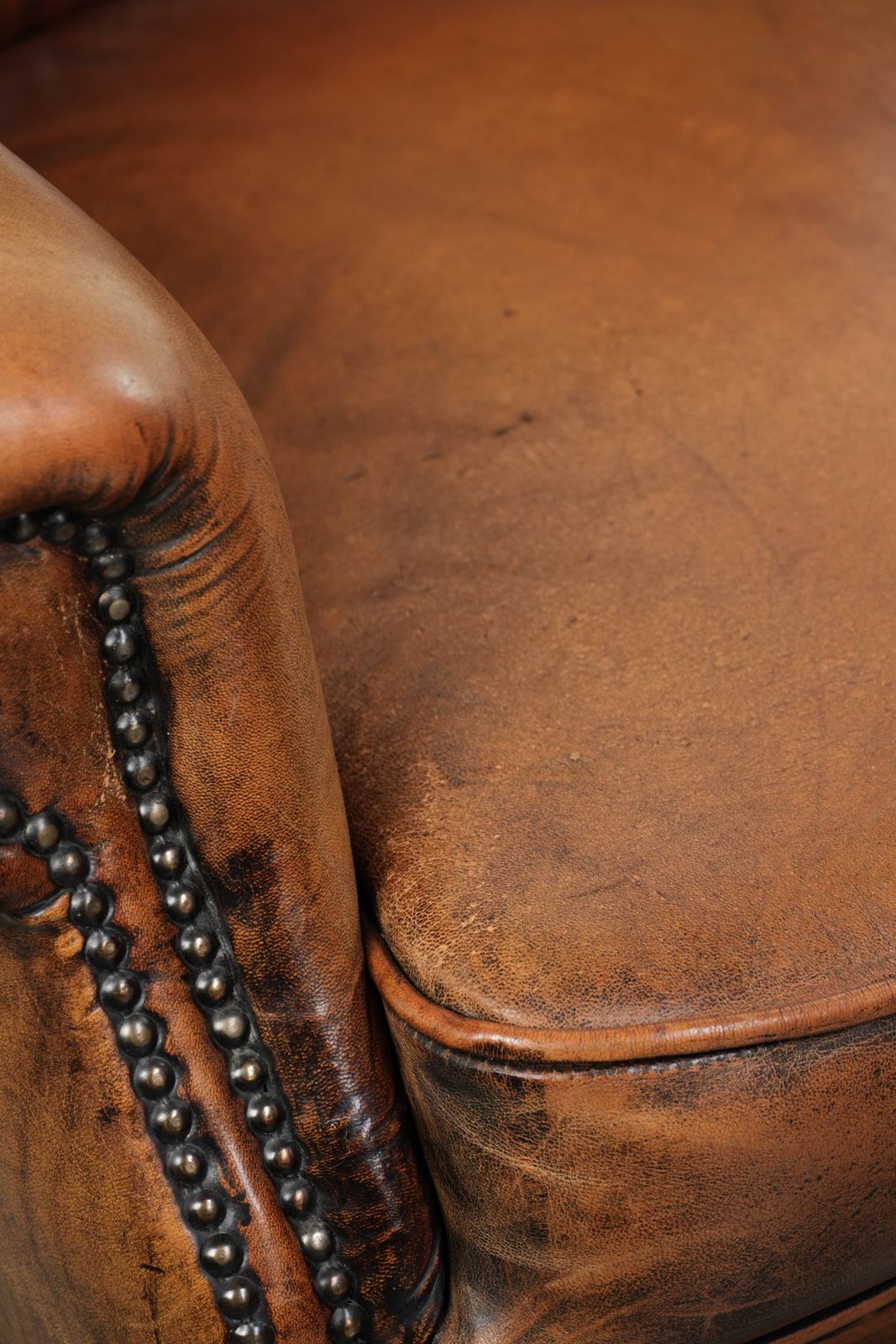 photo for sale Comfortable Wing Armchair Made Of Sheepskin Finished With Decorative Studs And A Characterful English Style Appearance.