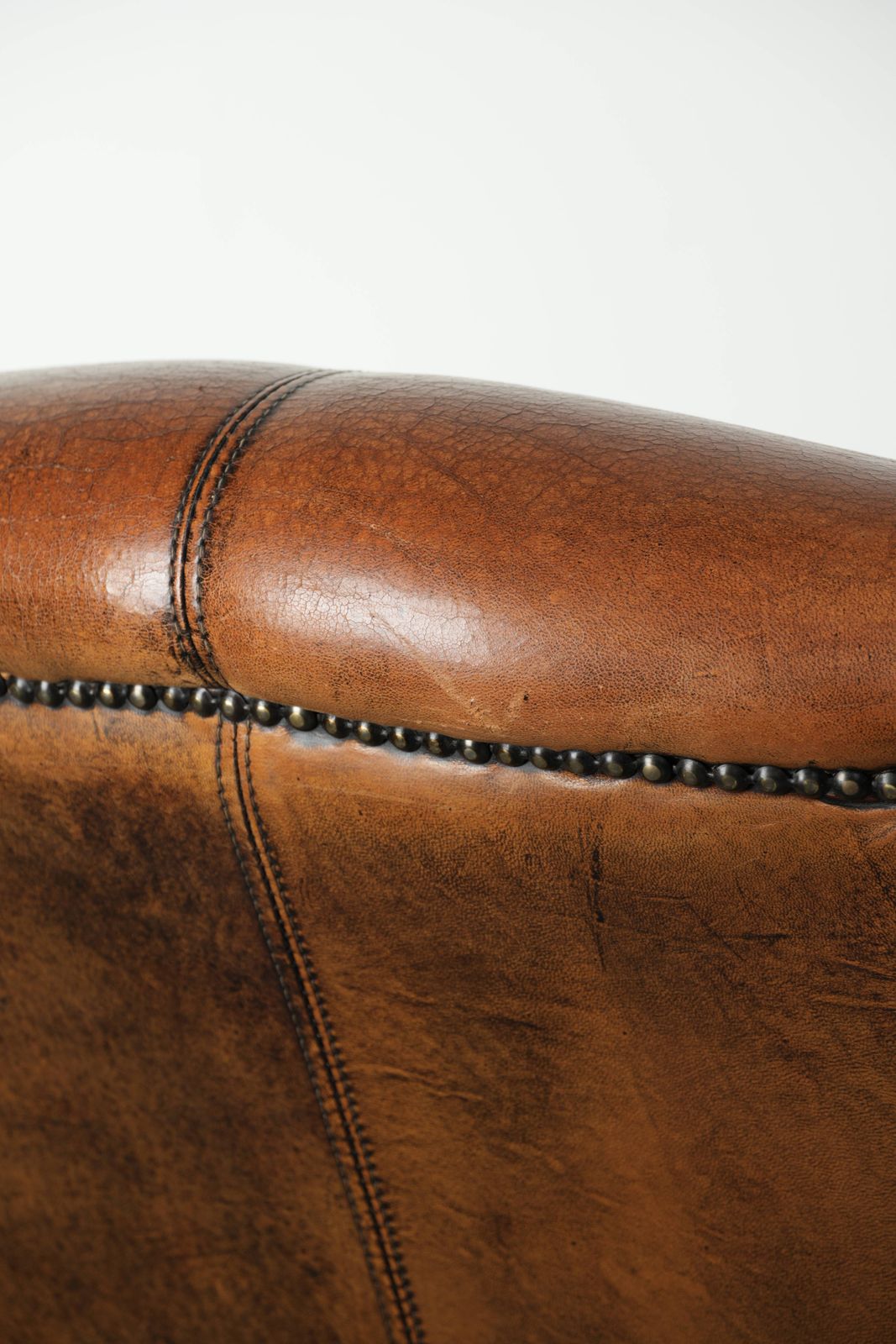 990.0 Comfortable Wing Armchair Made Of Sheepskin Finished With Decorative Studs And A Characterful English Style Appearance. photo