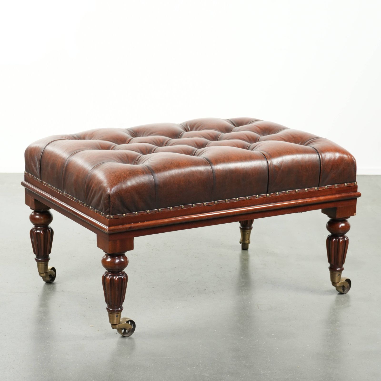 Large Brown Cowhide Chesterfield Ottoman In English Style With Elegant Legs And Brass Casters