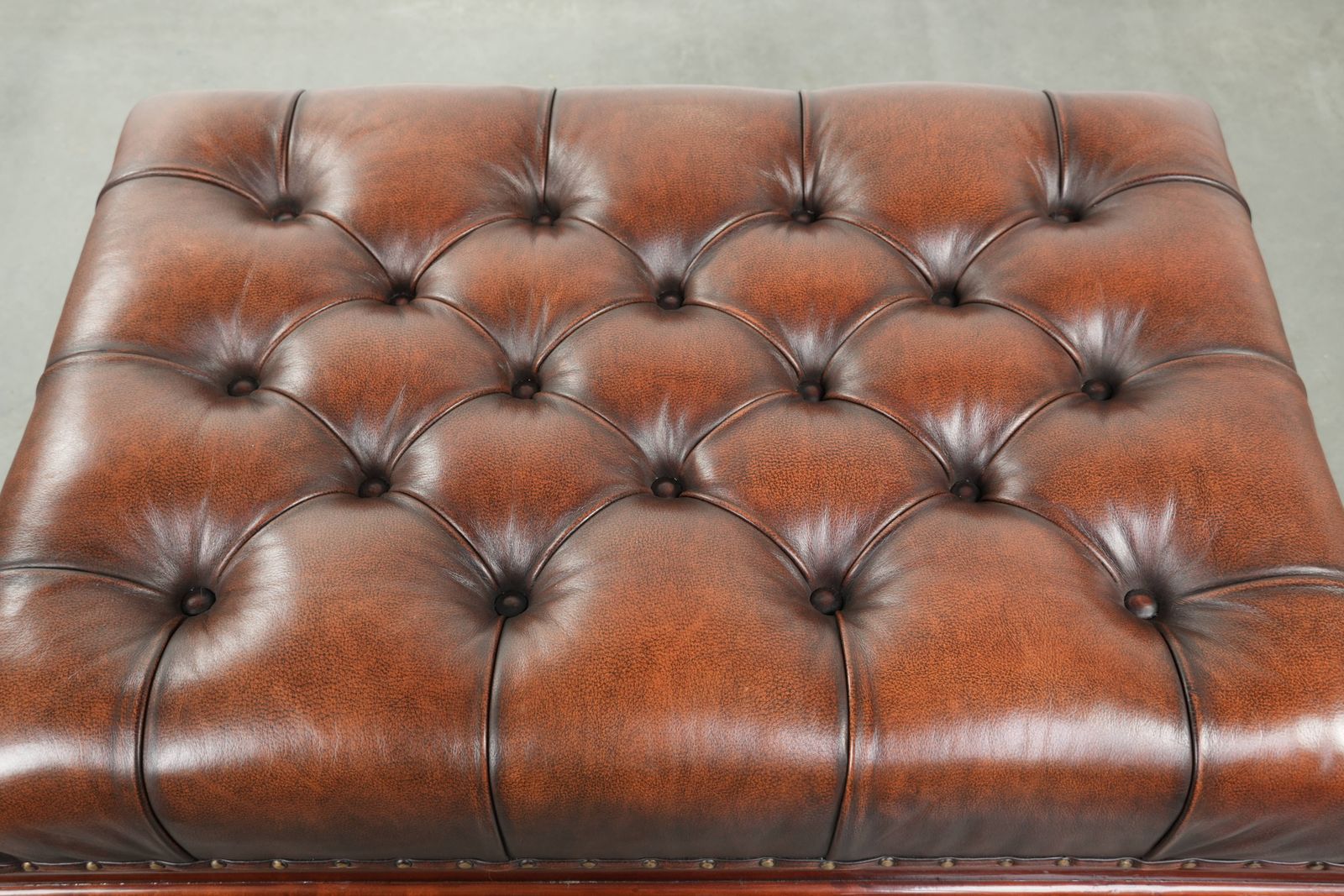 Large Brown Cowhide Chesterfield Ottoman In English Style With Elegant Legs And Brass Casters photo vinterior