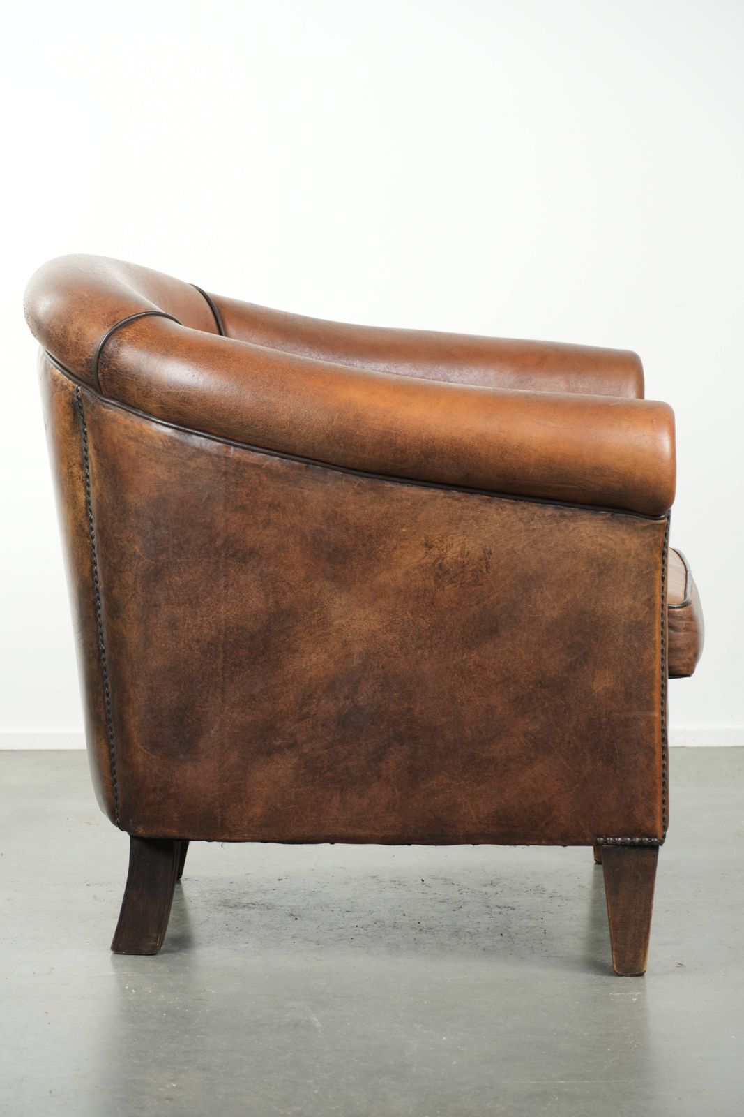 Characterful And Comfortable Sheepskin Club Armchair With A Beautiful Patina And A Refined Finish With Black Piping. photo for sale