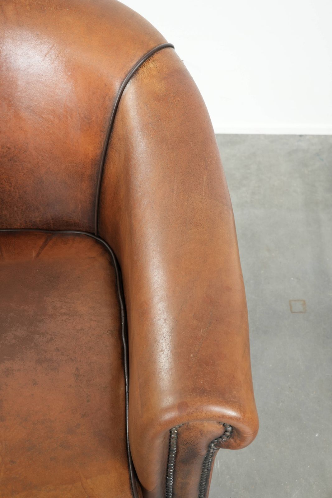 Characterful And Comfortable Sheepskin Club Armchair With A Beautiful Patina And A Refined Finish With Black Piping. photo vintage