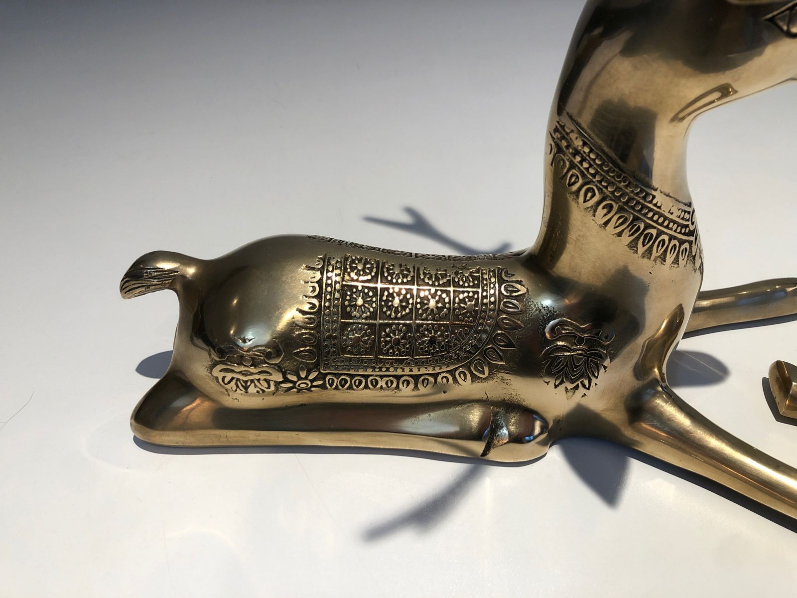 photo for sale Pair Of Bronze Reclining Deer Engraved With Shamanic Motifs. French Work. Circa 1970