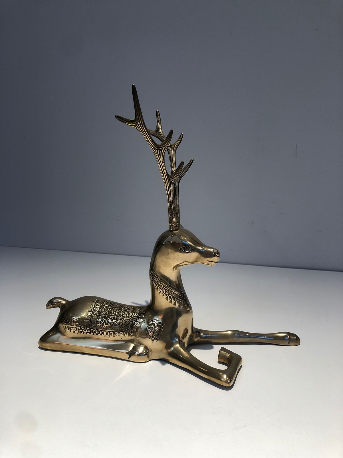 photo vintage Pair Of Bronze Reclining Deer Engraved With Shamanic Motifs. French Work. Circa 1970