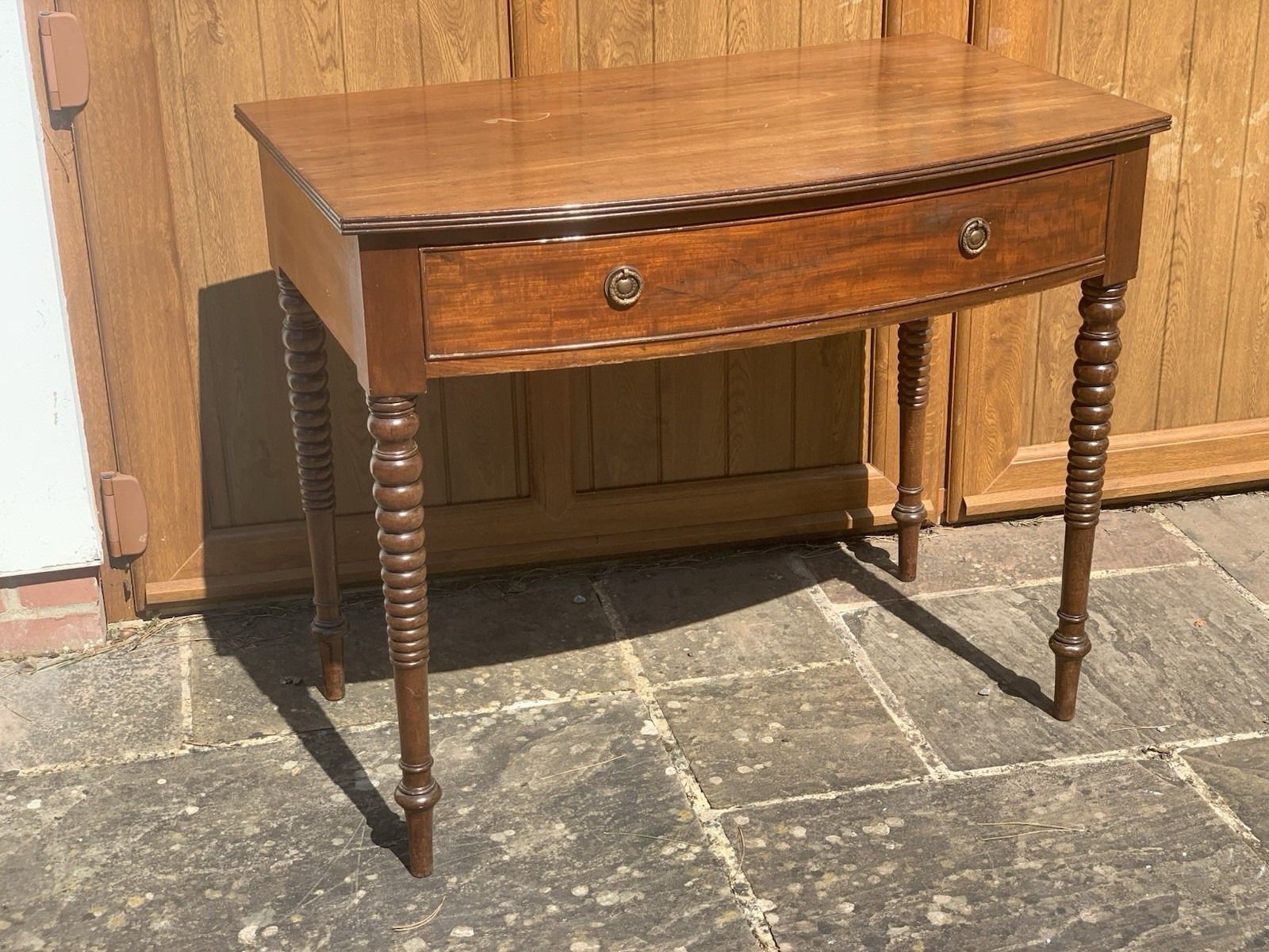 A Regency Bowfront Side Table With Bobbin Legs.