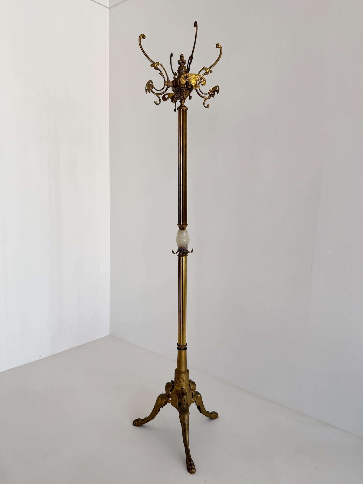 Italiaanse messing kapstok met onyx marmeren middenstuk, draaiende kroon en decoratieve halsboom photo furniture