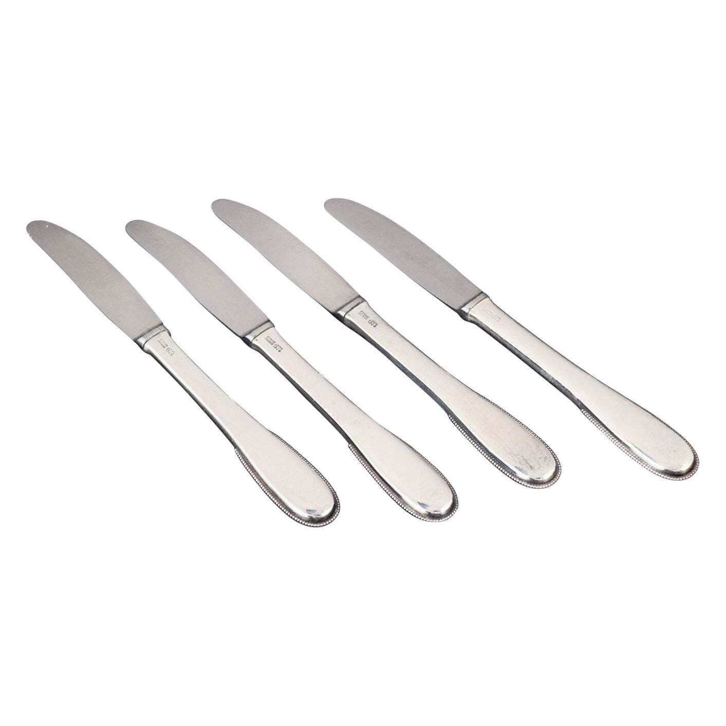 Evald Nielsen. Set van vier lunchmessen in sterling zilver en roestvrij staal.