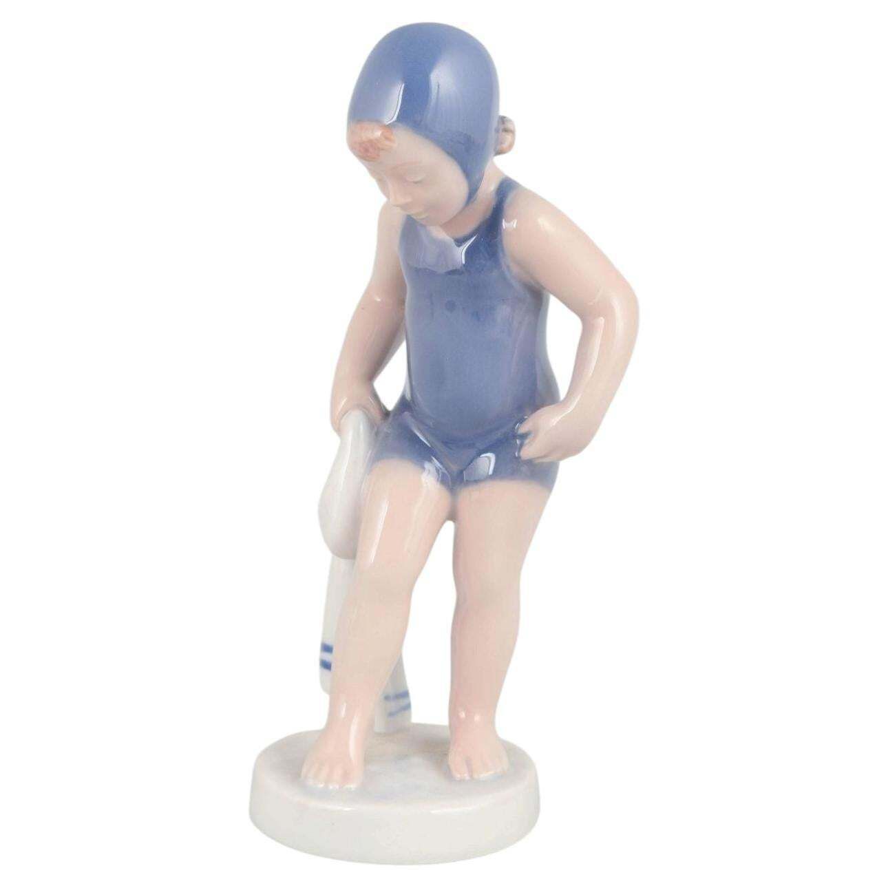 Royal Copenhagen. "The Swimmer" Porseleinen Beeldje Van Meisje In Blauwe Badpak.