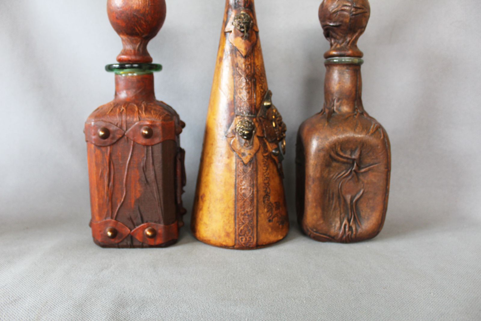 photo for sale Set Of 3 Vintage Italian Leather Wrapped Glass Decanters, Italy Wrapped Bottle, Whisky Cognac, Lion Head, Hand Decorated, Hooks, Stopper