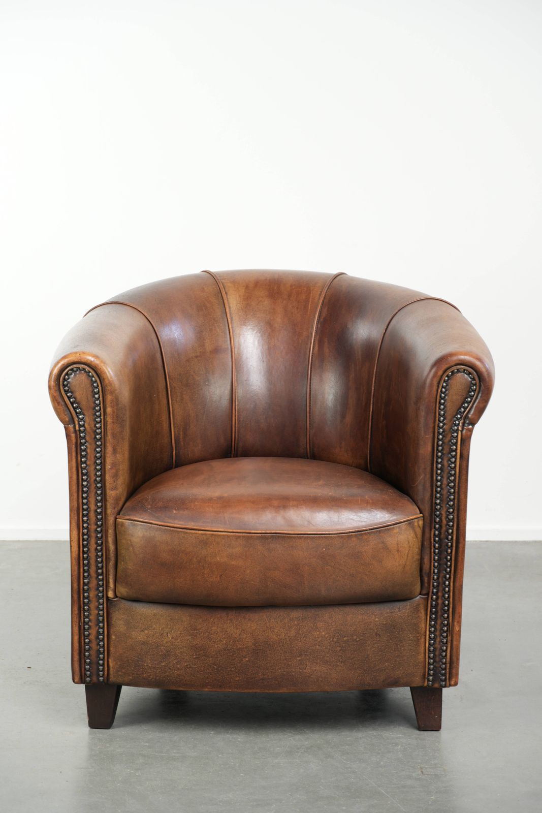 Sturdy And Characterful Sheepskin Club Armchair With A Beautiful Patina, Finished With Decorative Nails. photo furniture