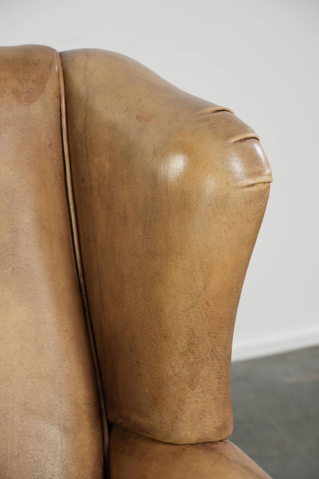 photo furniture Beautiful Light Cowhide Wing Armchair With A Timeless English Look And Good Seating Comfort