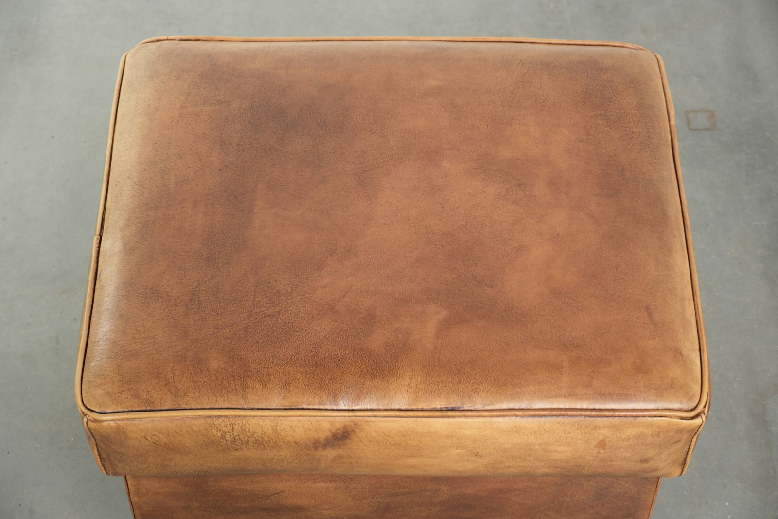 Characterful Cowhide Leather Ottoman With A Beautiful Patina, Finished With Decorative Nails. photo vinterior