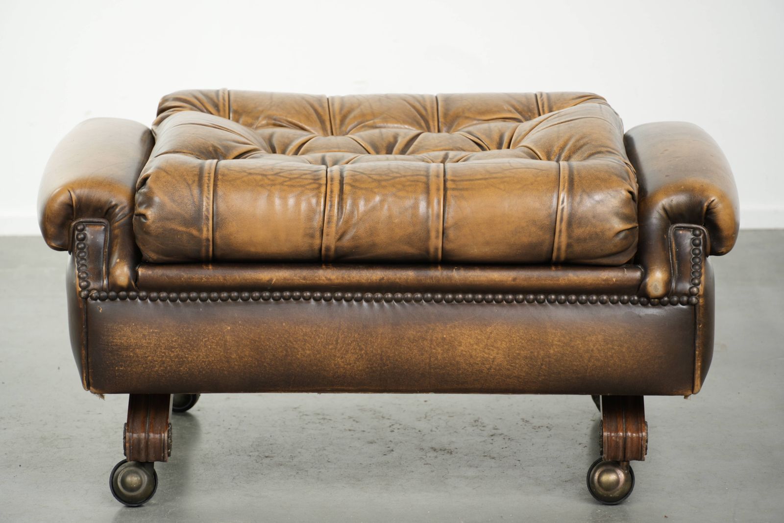 Unique And Elegant English Chesterfield Ottoman In Cowhide Leather On Wheels And Finished With Decorative Nails. photo Furniture