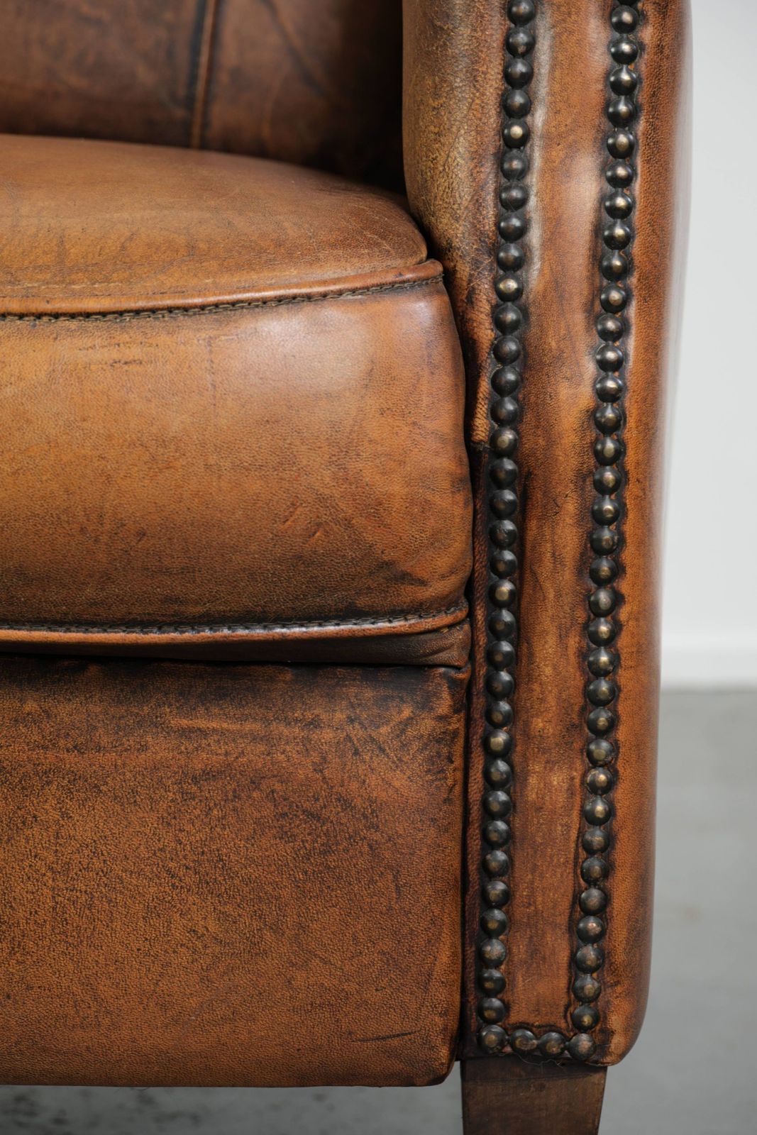 884.0 Comfortable, Characterful Sheepskin Armchair Finished With Decorative Nails And A Beautiful Patina photo