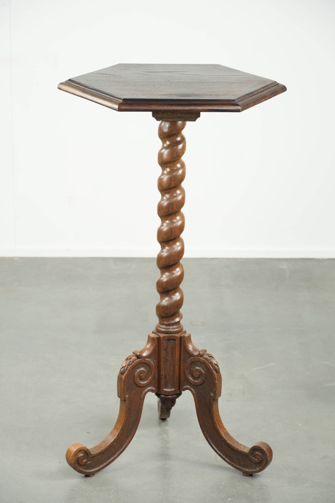 Elegante antieke hoge eiken plant/bijzettafel met fraai houtsnijwerk en een gedraaide poot photo Meubels