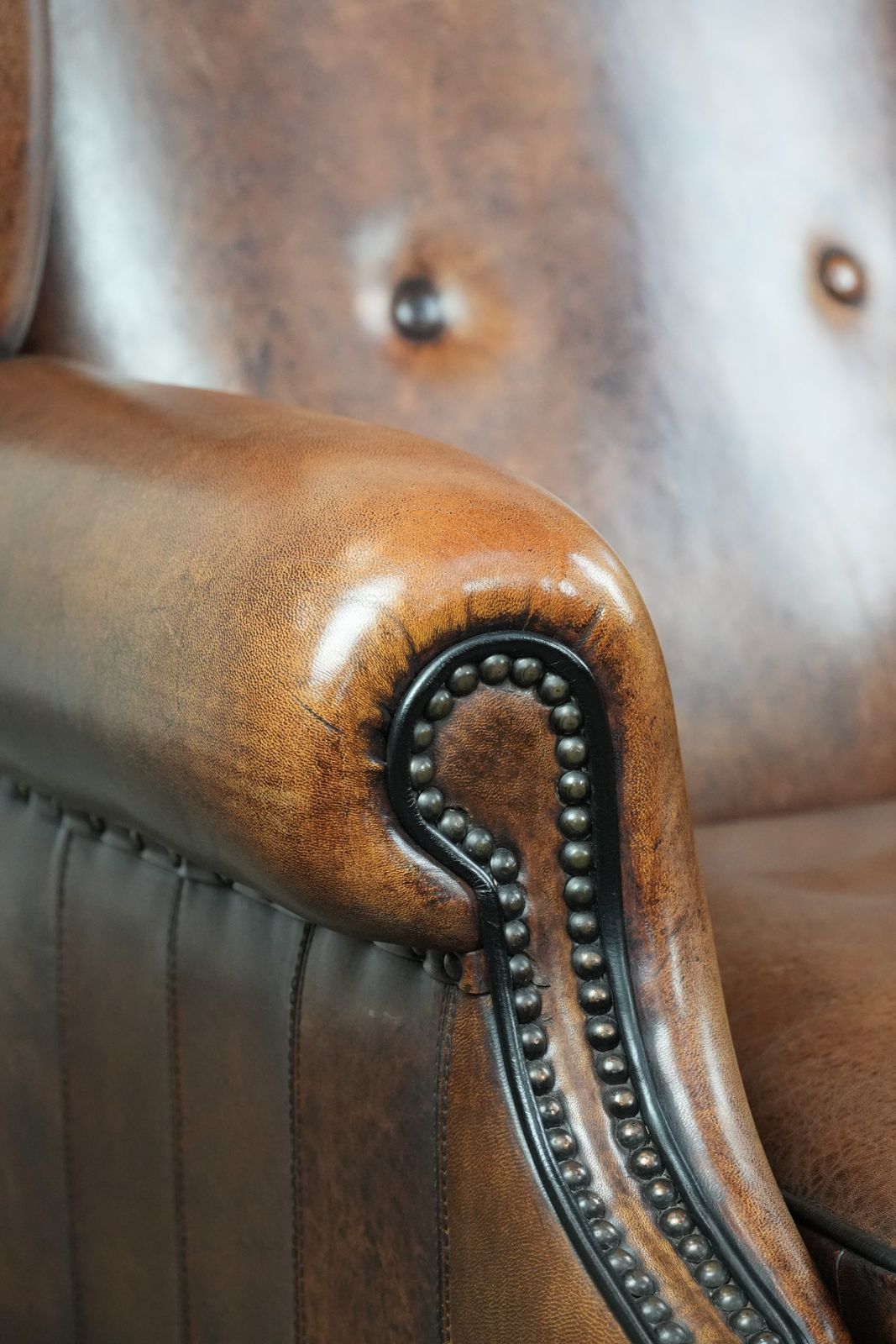 photo for sale Timeless And Comfortable Sheepskin Wing Armchair With Beautiful Colors And A Finish With Decorative Nails And Black Piping.