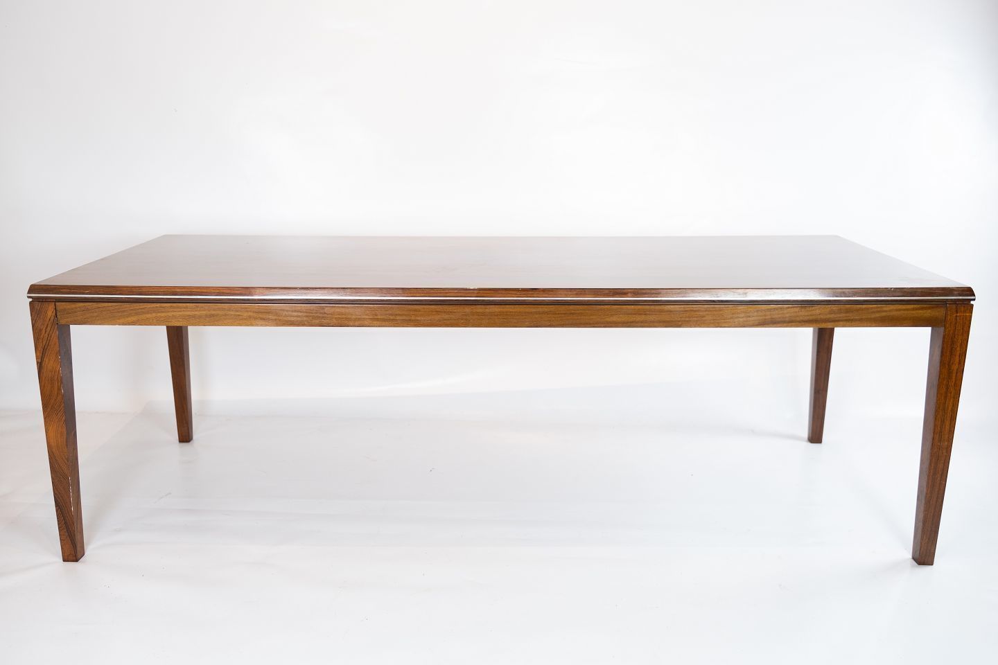 Coffee Table Made In Rosewood Decorated With Metal Edge Of Danish Design From The 1960s.