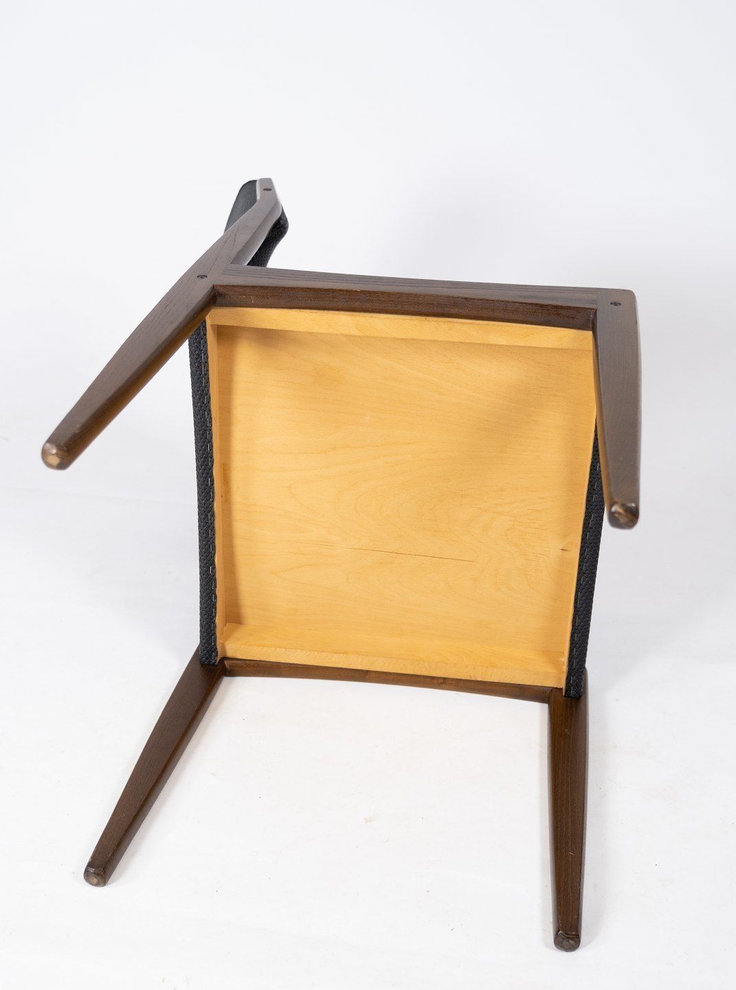 photo for sale Set Of Four Dining Chairs Of Black Upholstery And Dark Wood Of Danish Design From The 1960s.