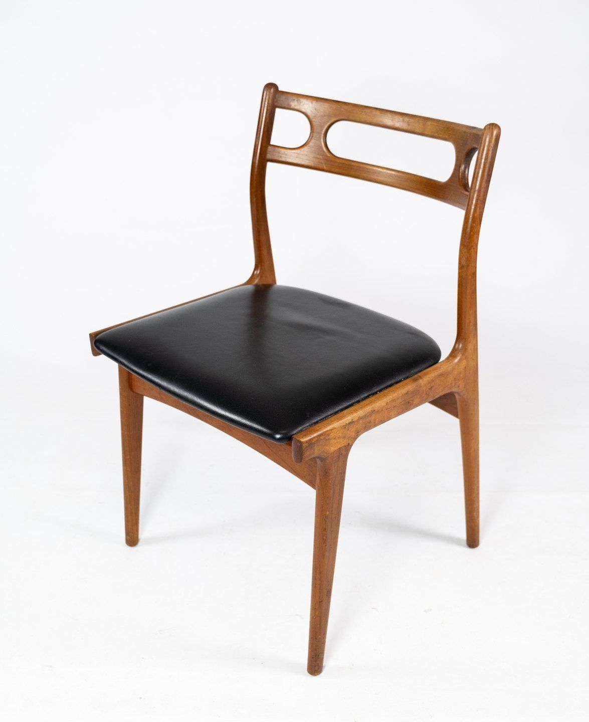 A Set Of Four Dining Chairs In Teak And Upholstered With Black Leather Of Danish Design From The 1960s. photo for sale