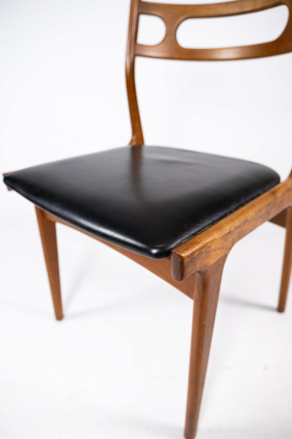 A Set Of Four Dining Chairs In Teak And Upholstered With Black Leather Of Danish Design From The 1960s. photo Furniture