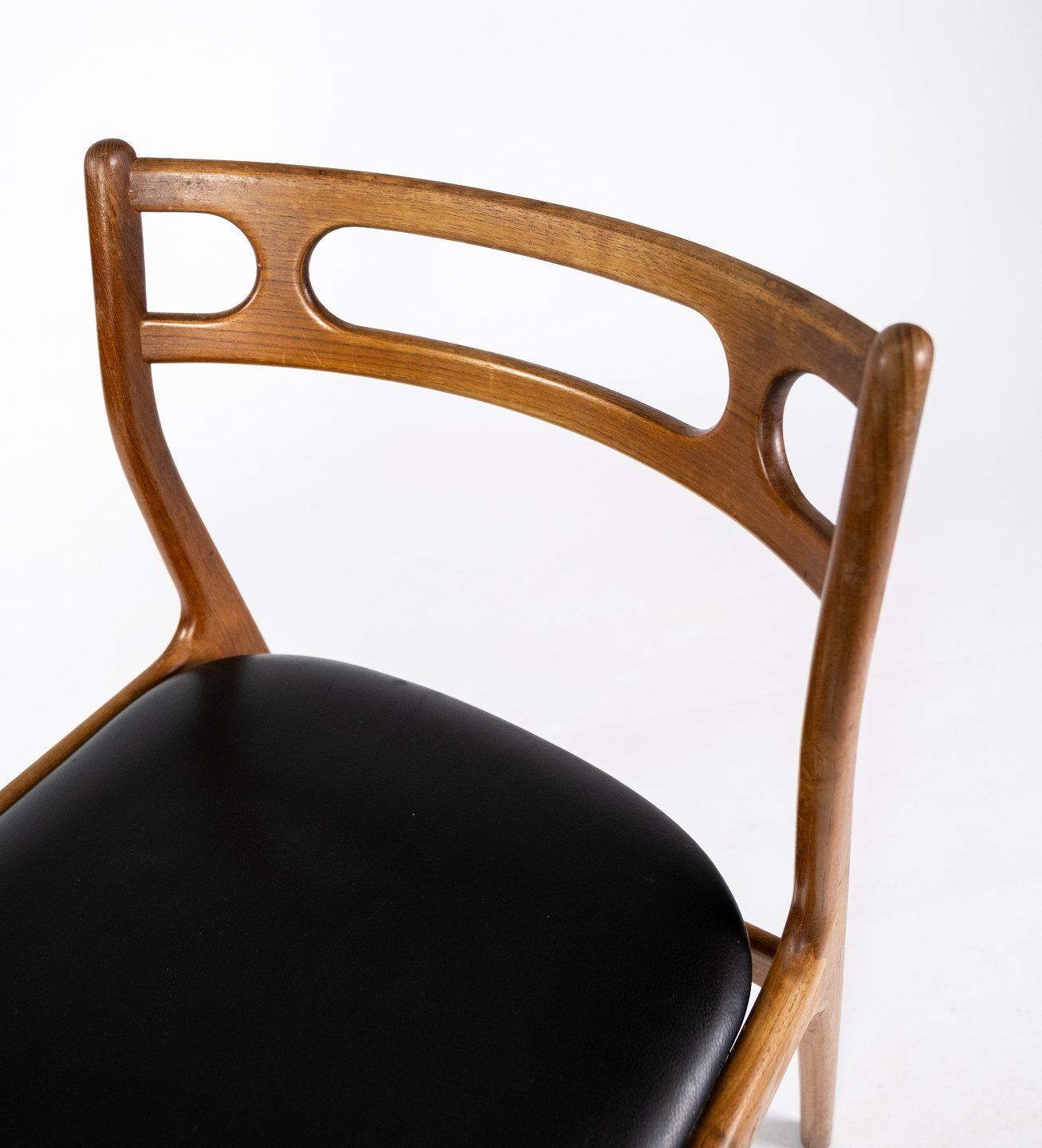 A Set Of Four Dining Chairs In Teak And Upholstered With Black Leather Of Danish Design From The 1960s. photo 2265.0