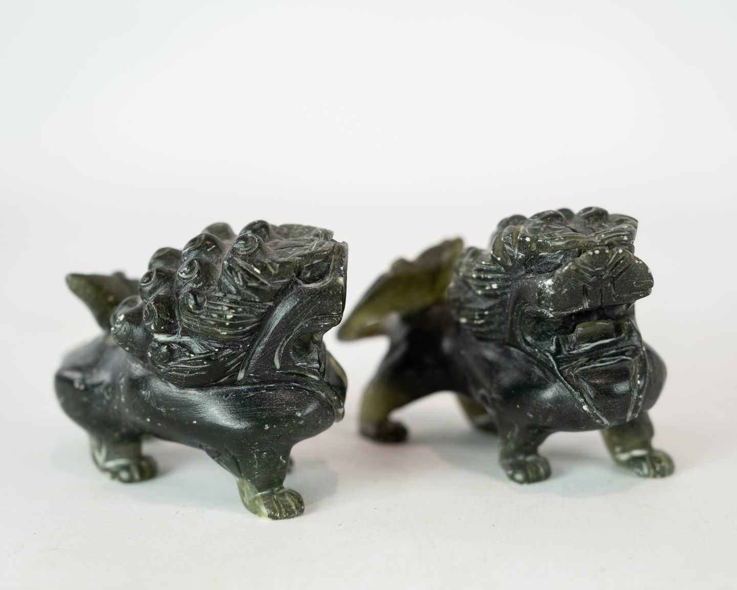 A Pair Of Soapstone Figures In The Shape Of Lions