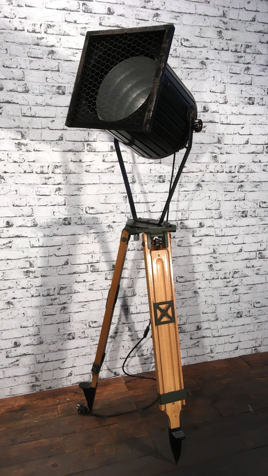 Black Vintage Industrial Spotlight On Wooden Tripod  photo for sale