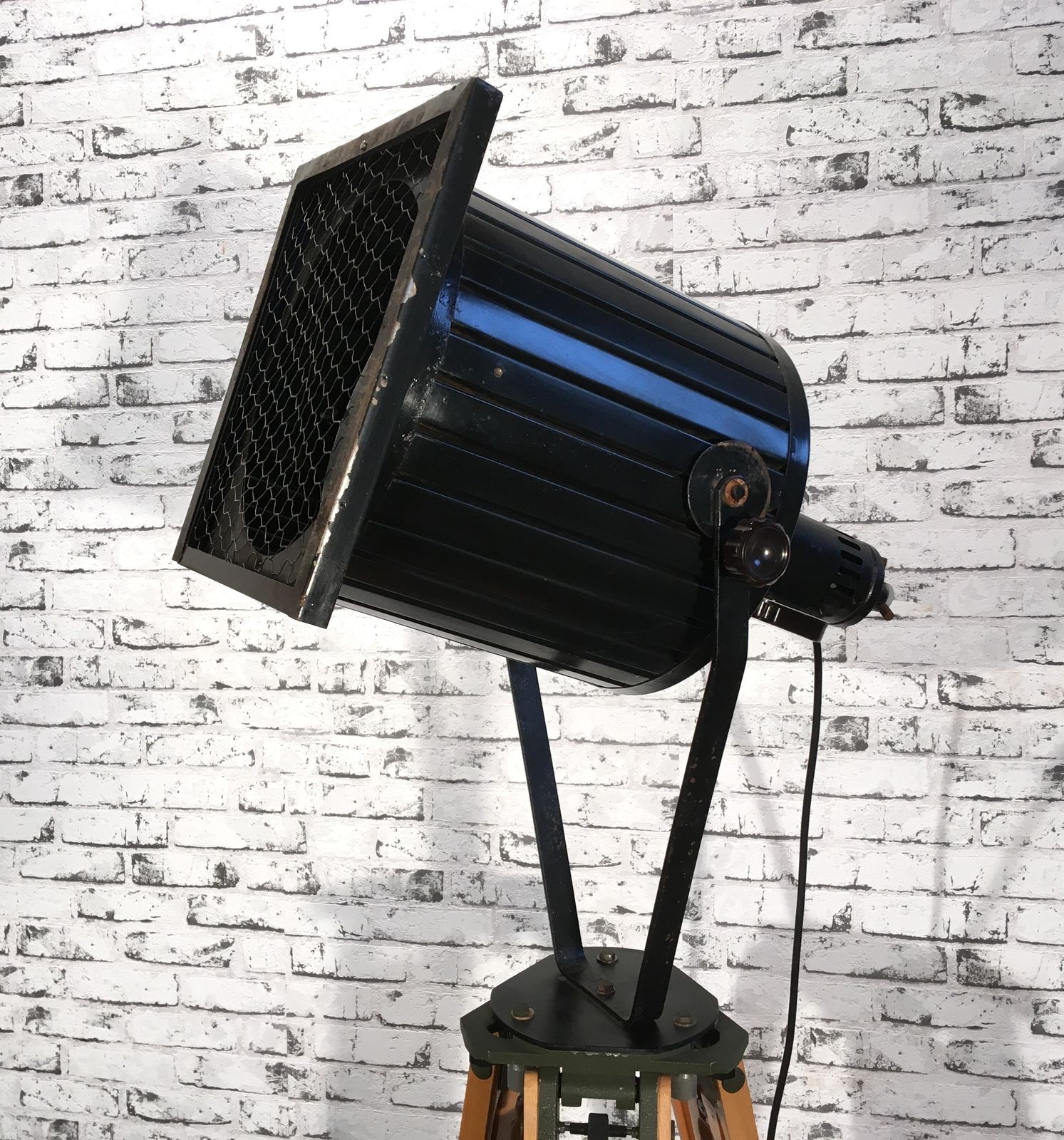 Black Vintage Industrial Spotlight On Wooden Tripod  photo 599.0