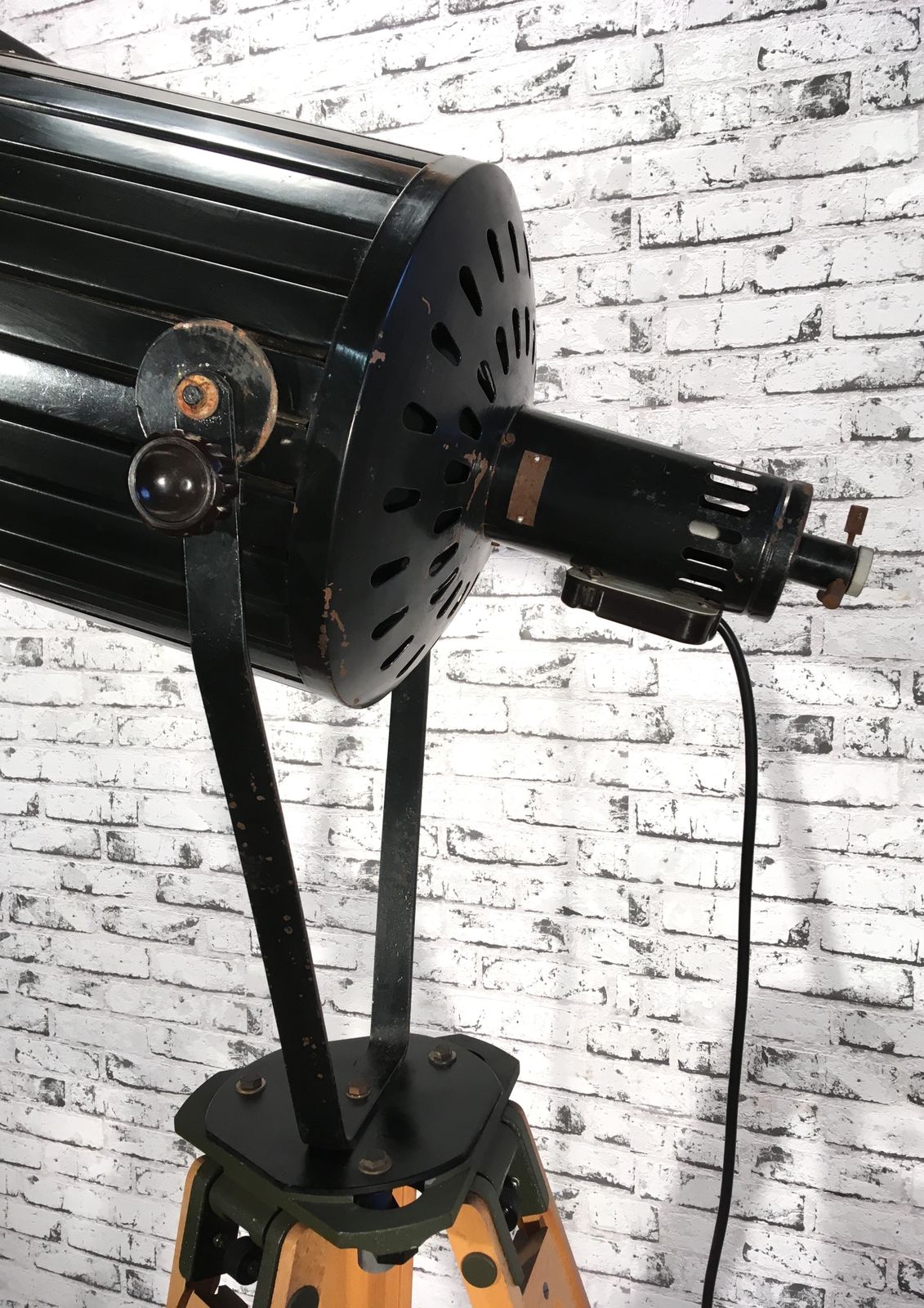 Black Vintage Industrial Spotlight On Wooden Tripod  photo vintage