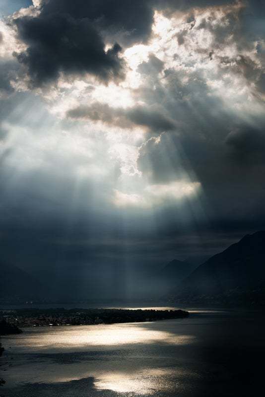 "Dramatic Sky With Sunbeams Over Lago Maggiore, Switzerland" By Assalve