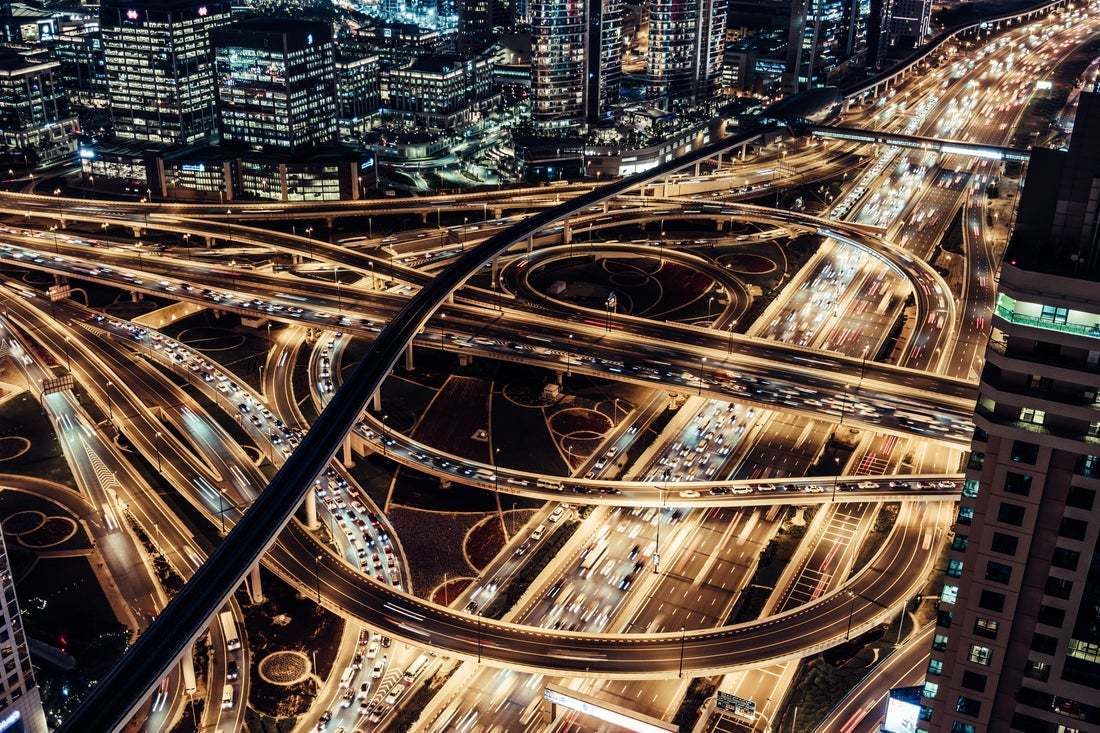 "Aerial View Of Dubai City Traffic And Road Intersection At Night" By Aerialperspective Images