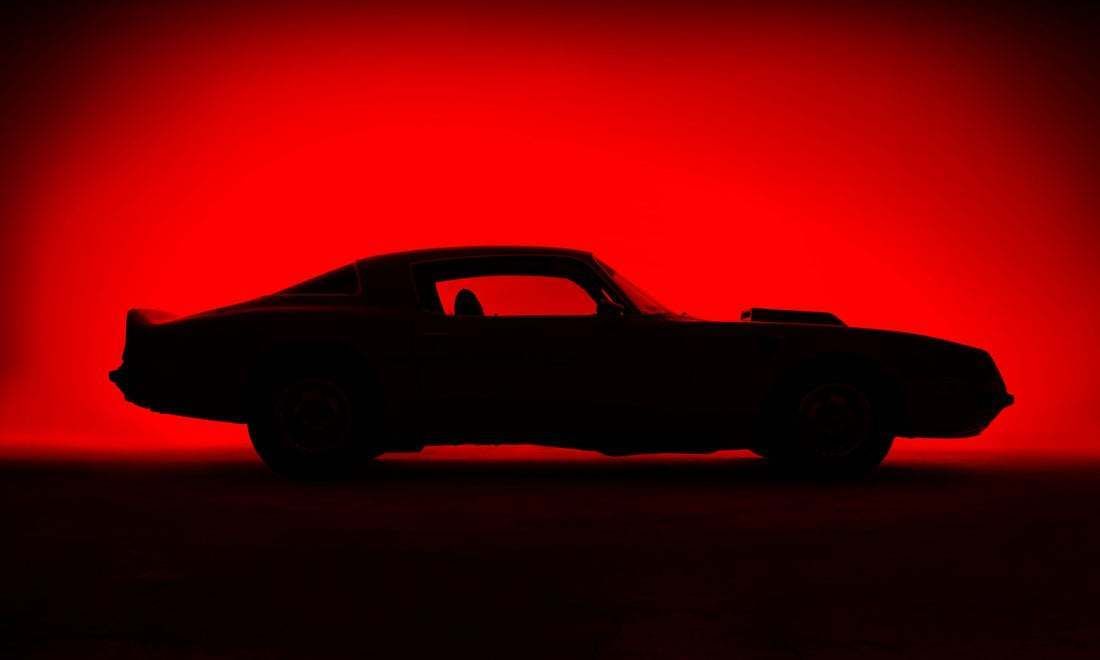 "Silhouette Of An Old Fashion Muscle Car On A Red Background" By Casphotography