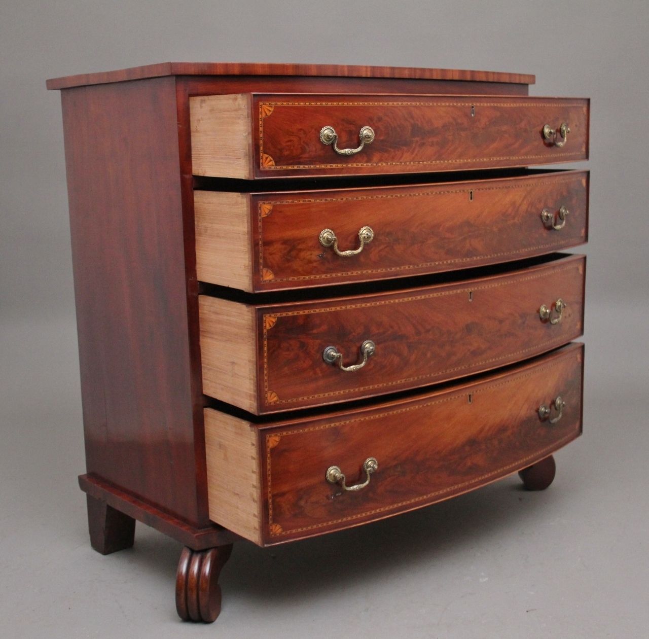 A Highly Decorative Early 19th Century Flame Mahogany And Inlaid Bowfront Chest Of Drawers photo for sale