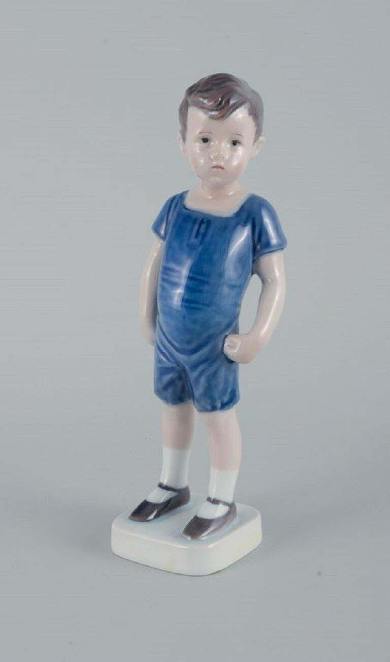Royal Copenhagen, A Rare Figure Of A Boy. Model Number 519. photo furniture