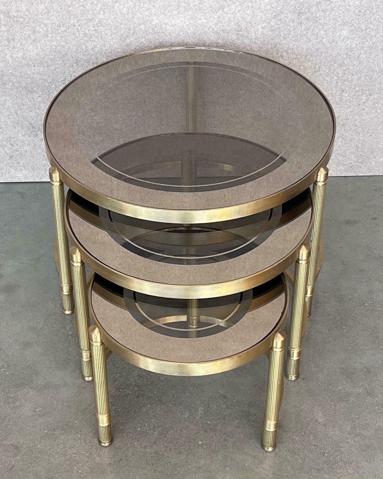 Set Of Three Round Brass Nesting Tables With Smoked Pink Glass Tops photo for sale