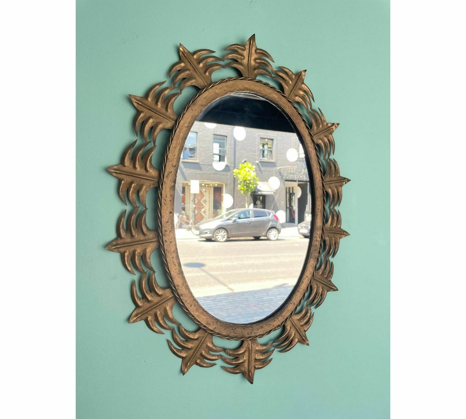 A Spanish Sunburst 1950s Gilt Metal Oval Mirror With Ornate Edging. photo Home Decor
