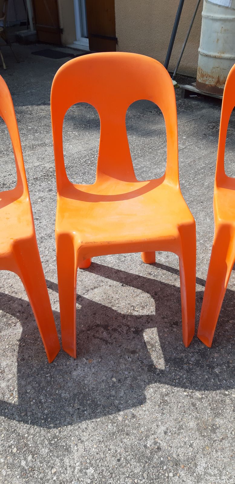 12 Stackable Orange Plastic Chairs photo for sale