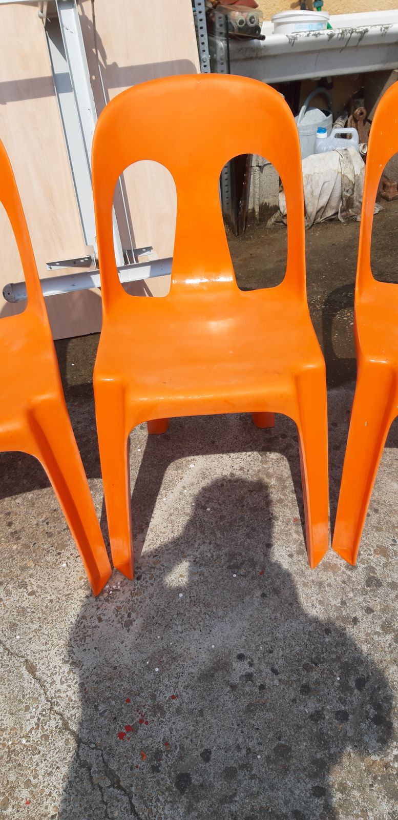 368.28 12 Stackable Orange Plastic Chairs photo