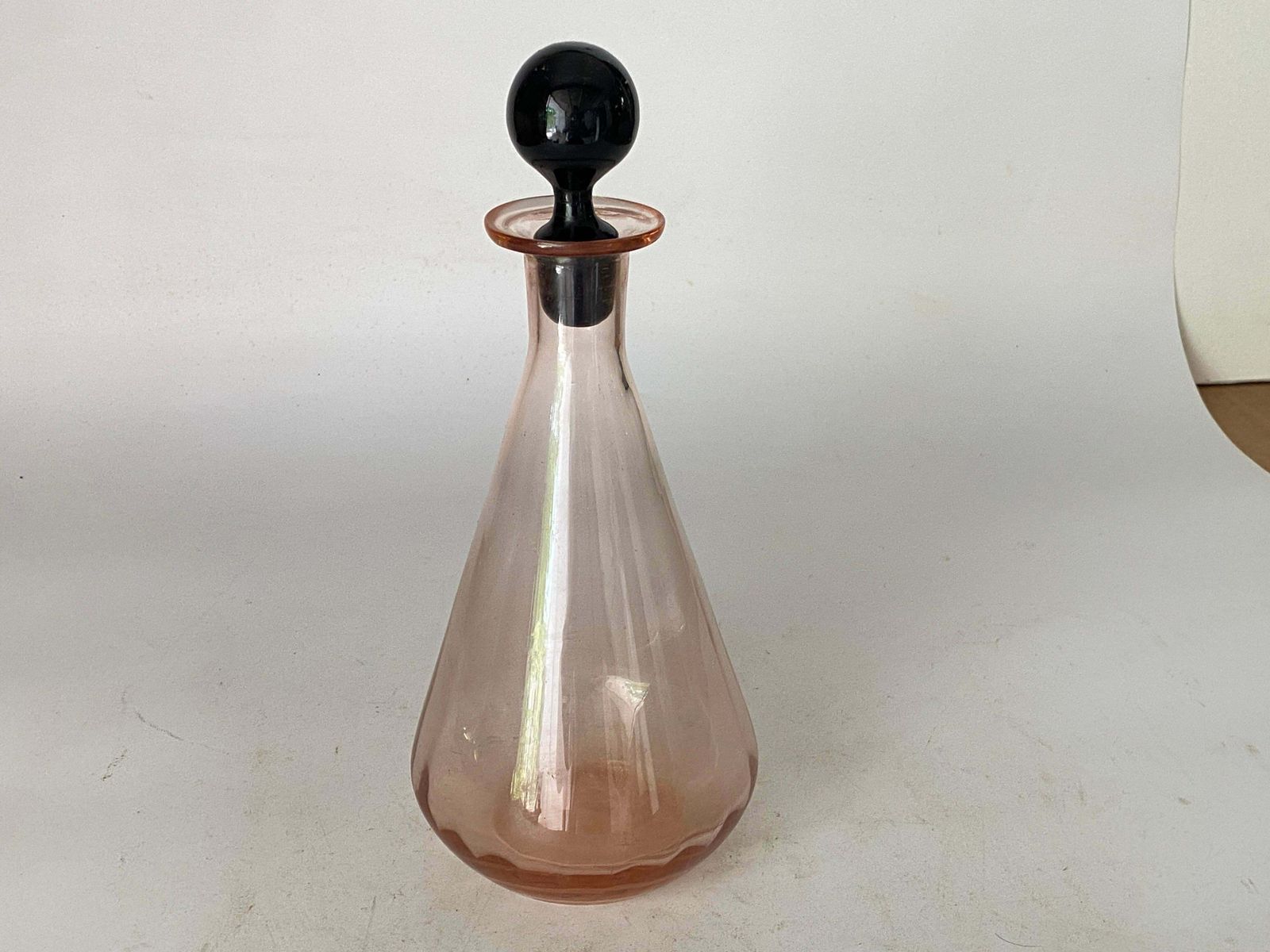 photo furniture Decorative Vintage Pink Glass Bottle In Glass With Black Cap, France, Circa 1940