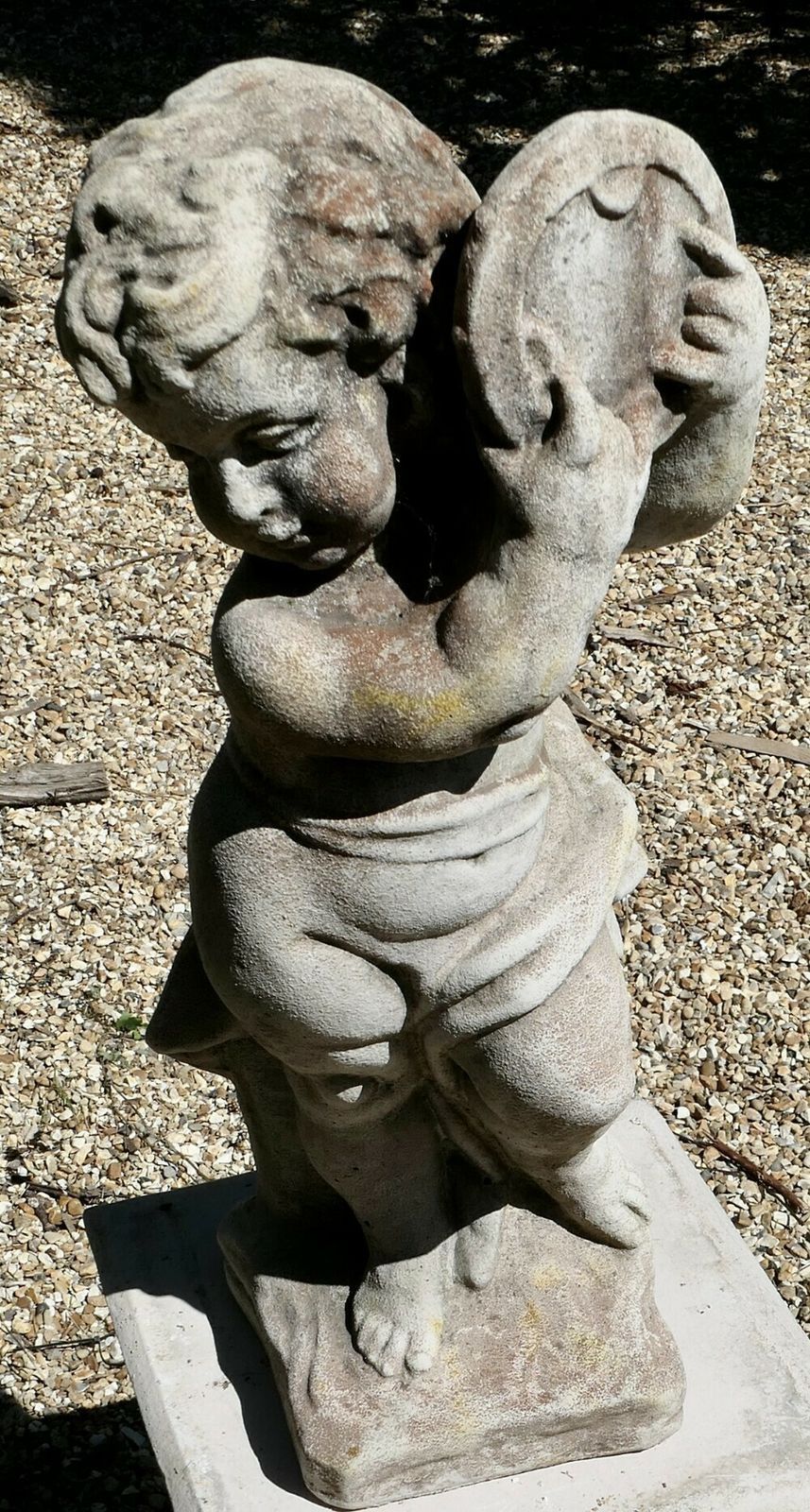 Old Weathered Statue Of A Putti Playing Tambourine photo furniture
