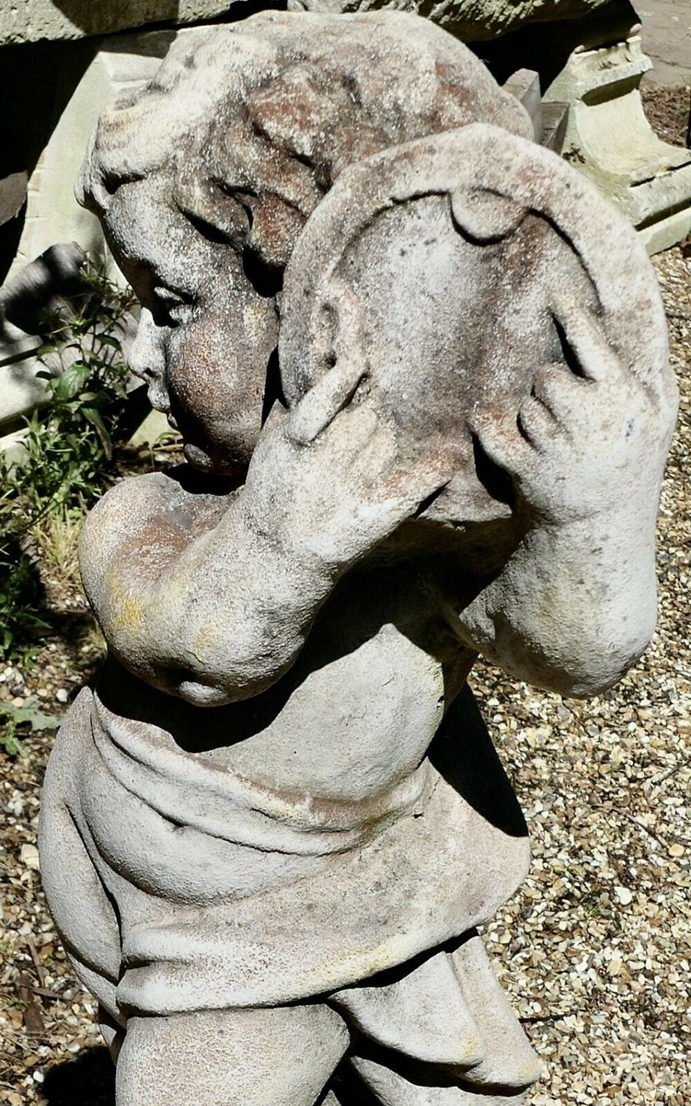 Old Weathered Statue Of A Putti Playing Tambourine photo for sale