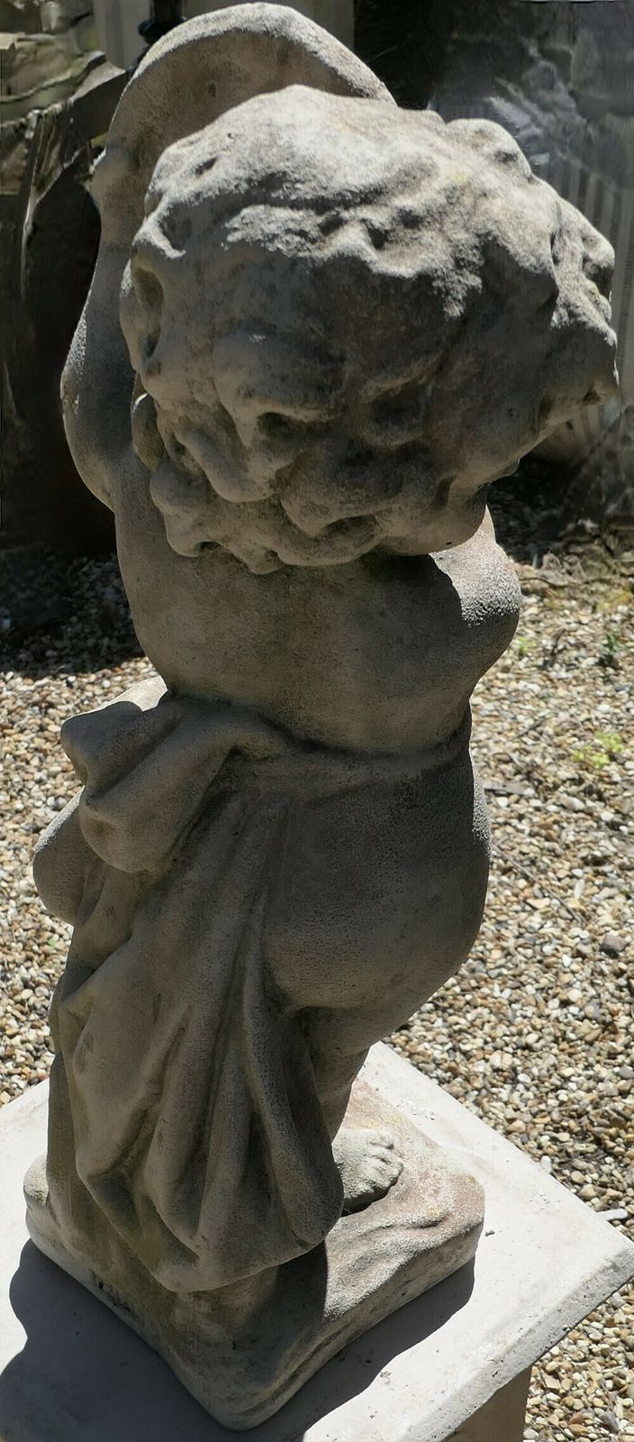 Old Weathered Statue Of A Putti Playing Tambourine photo vinterior
